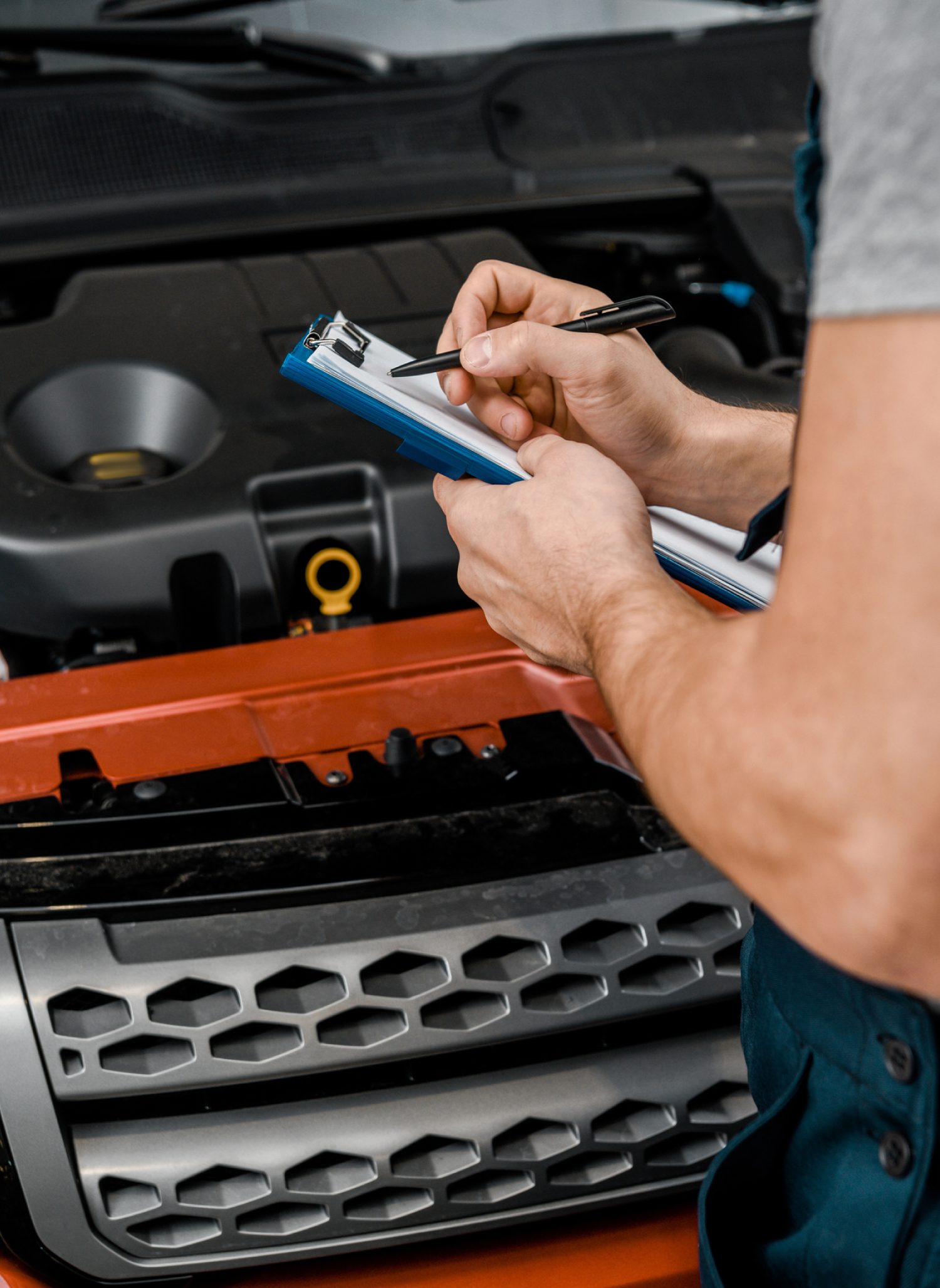 mechanic writing a list with a pen - ADL Auto Repair & Driveshafts