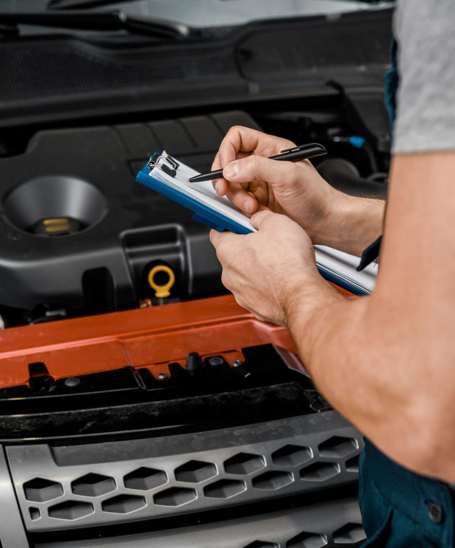 mechanic writing a list with a pen - ADL Auto Repair & Driveshafts