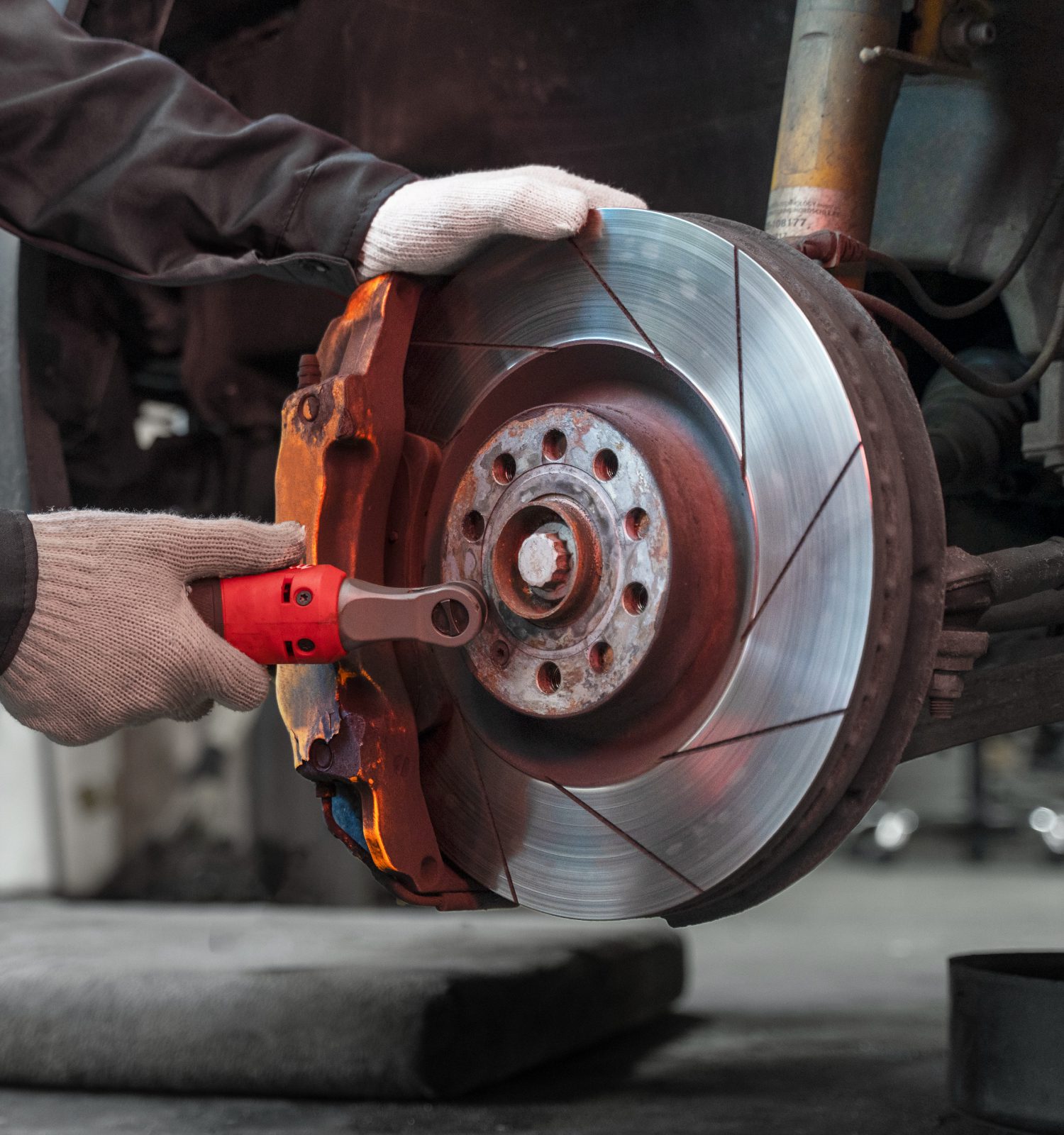 mechanic checking brakes and pads - ADL Auto Repair & Driveshafts