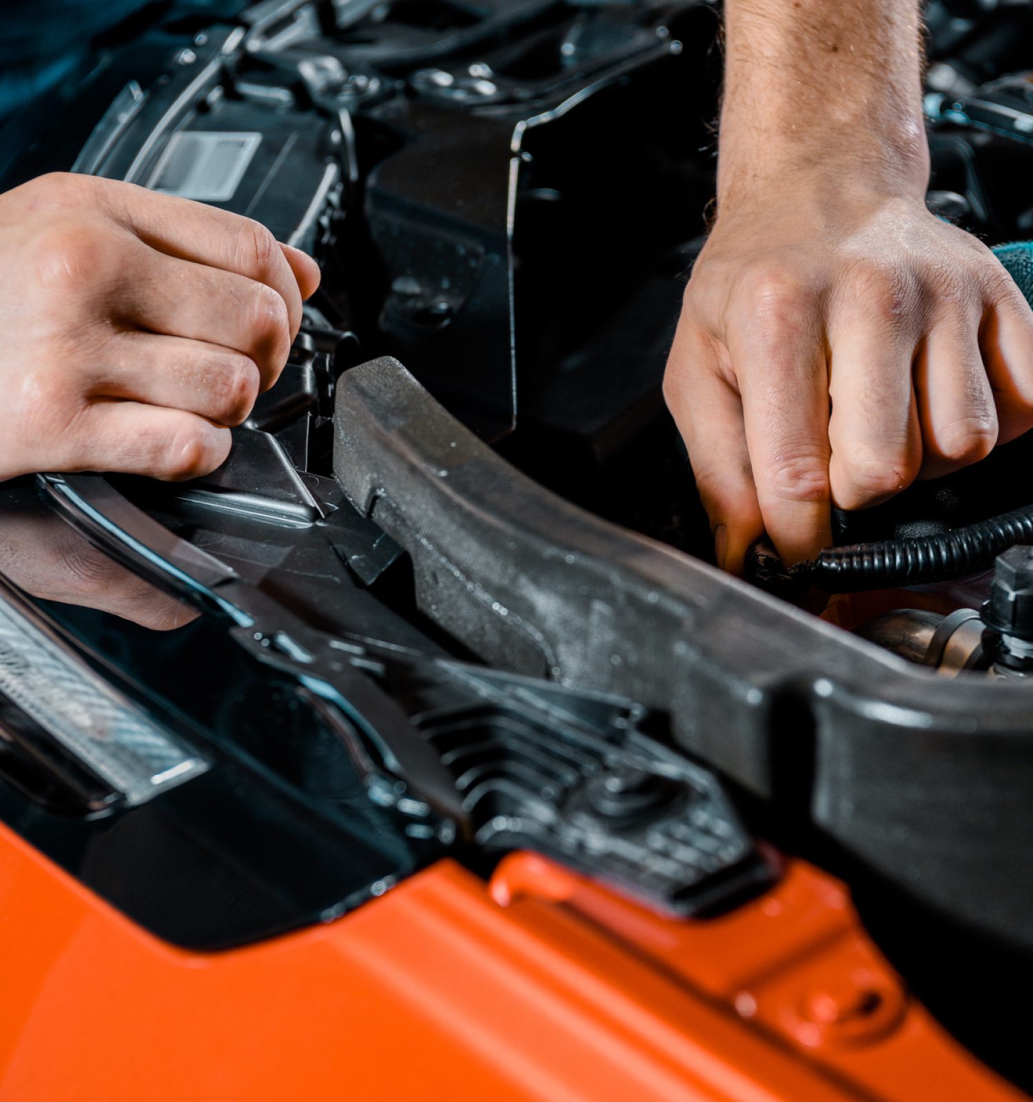 mechanic checking the inside hood of a vehicle - ADL Auto Repair & Driveshafts