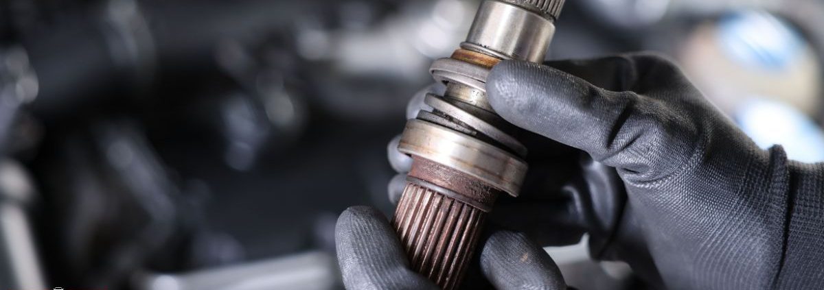 mechanic with a vehicle driveshaft - ADL Auto Repair & Driveshafts suspension repair