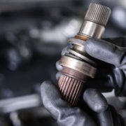 ADLAutoRepair&Driveshafts-driveshaft-010820261 mechanic with a vehicle driveshaft - ADL Auto Repair & Driveshafts suspension repair