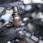 ADLAutoRepair&Driveshafts-driveshaft-010820262 mechanic with a vehicle driveshaft - ADL Auto Repair & Driveshafts Driveshaft Repair in Hugo