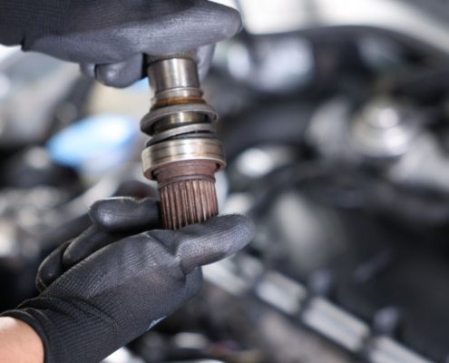 mechanic with a vehicle driveshaft - ADL Auto Repair & Driveshafts Driveshaft Repair in Hugo