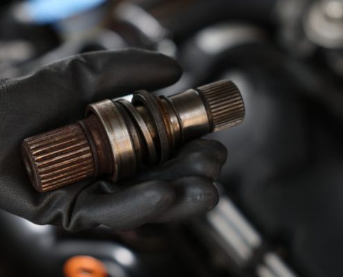 mechanic with a vehicle driveshaft - ADL Auto Repair & Driveshafts driveshaft
