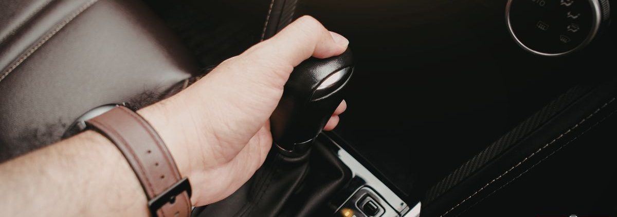 person shifting their vehicle - ADL Auto Repair & Driveshafts Driveshaft Balancing and Maintenance