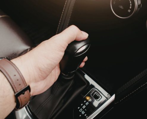 person shifting their vehicle - ADL Auto Repair & Driveshafts transmission fluid