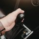 person shifting their vehicle - ADL Auto Repair & Driveshafts Driveshaft Balancing and Maintenance