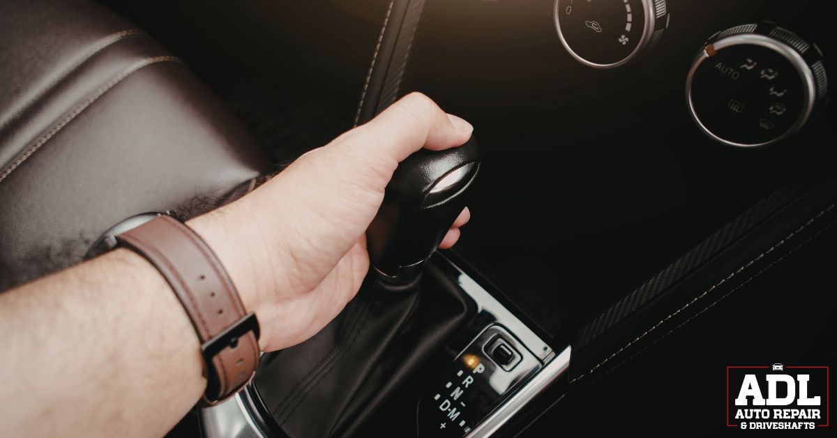 person shifting their vehicle - ADL Auto Repair & Driveshafts Driveshaft Balancing and Maintenance
