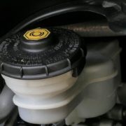 engine bay of vehicle with a close up of transmission fluid topper - ADL Auto Repair & Driveshafts vehicle maintenance
