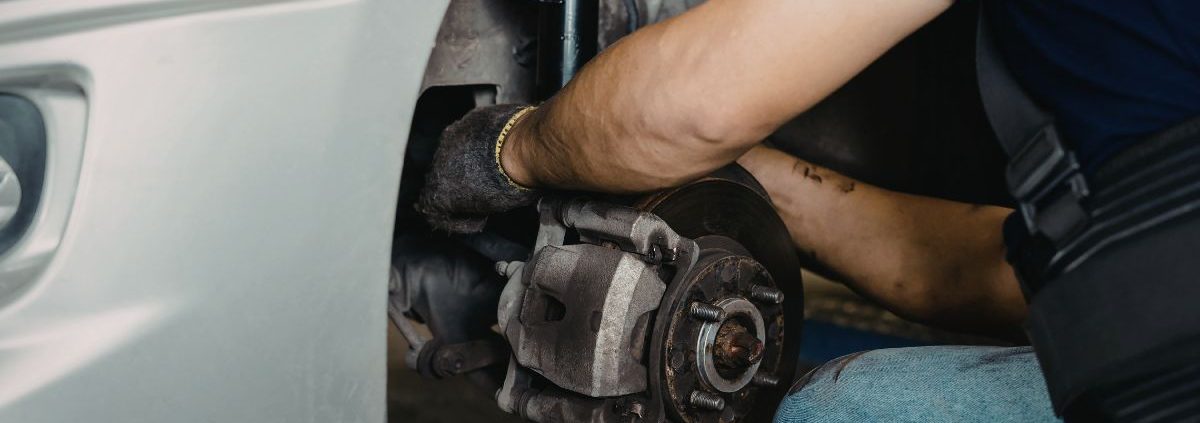 mechanic inspecting vehicle brake system - ADL Auto Repair & Driveshafts brake service