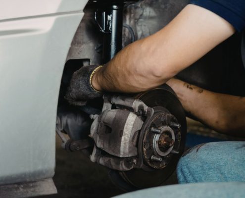 mechanic inspecting vehicle brake system - ADL Auto Repair & Driveshafts brake service