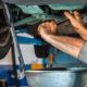 mechanic under a vehicle performing an oil change - ADL Auto Repair & Driveshafts oil change
