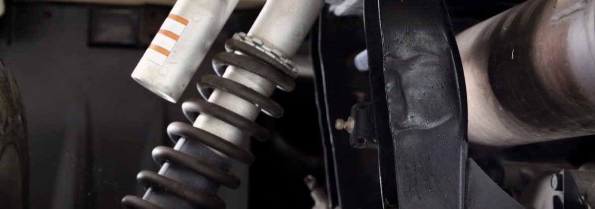 close up image of a vehicle suspension - ADL Auto Repair & Driveshafts suspension and alignment