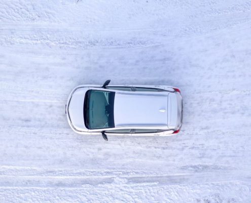 overhead image of a vehicle driving on a snow covered road - ADL Auto Repair & Driveshafts Driveshaft Repair in Hugo
