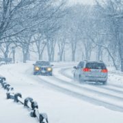 vehicles driving during a snow blizzard ADL Auto Repair & Driveshafts 4WD System Maintenance
