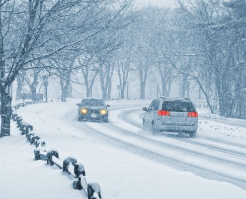 vehicles driving during a snow blizzard ADL Auto Repair & Driveshafts 4WD System Maintenance