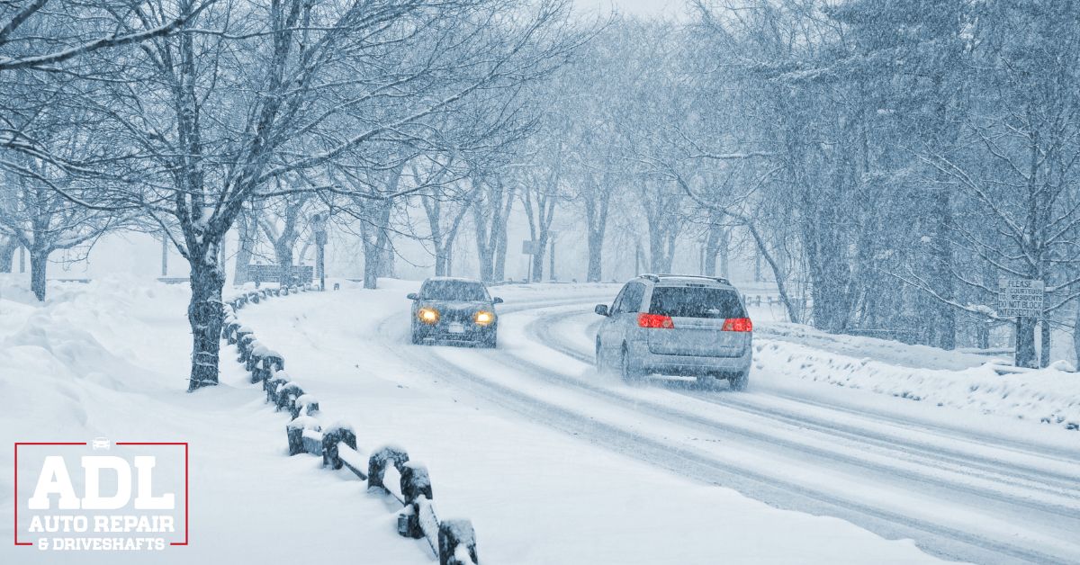two vehicles driving on a snow covered road - ADL Auto Repair & Driveshafts winter driveline maintenance